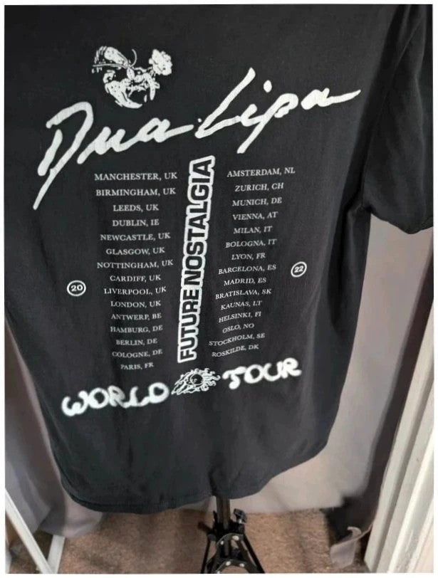 Dua Lipa black graphic tee with front polaroid print and back tour dates list.