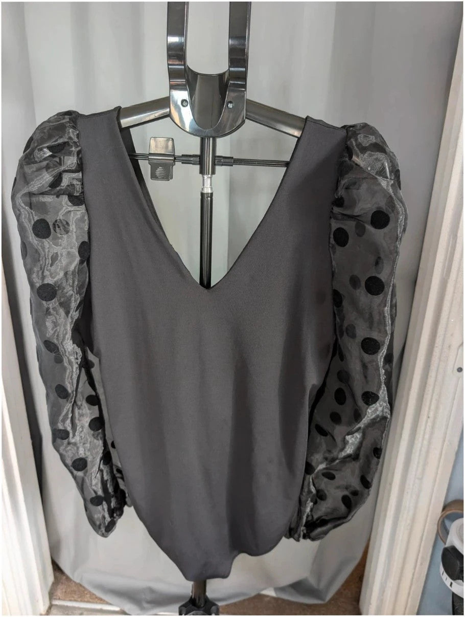 New Look black bodysuit with mesh polka dot sleeves and plunge V-neckline.