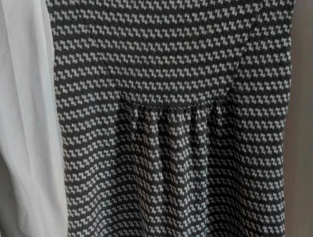 Apricot black and grey knit tunic dress with cowl neck and geometric pattern.