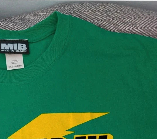 Gildan green graphic tee featuring Men In Black "Zap-Em Exterminators" logo and slogan.