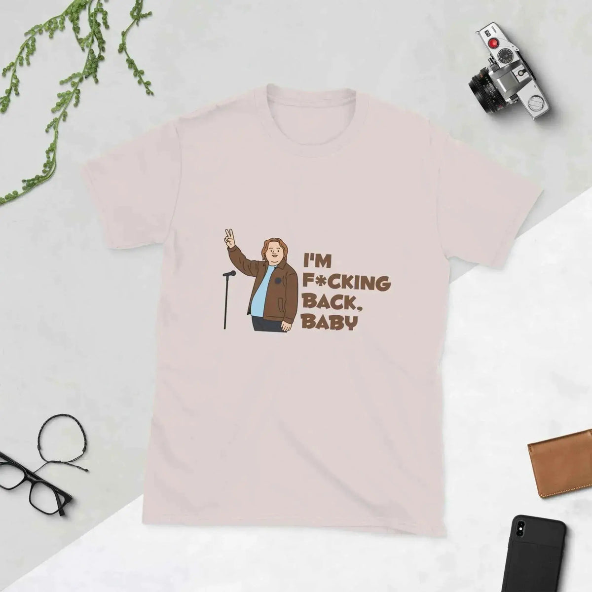 Unisex graphic cotton T-shirt in pale pink, front text "I'm f*cking back, baby".