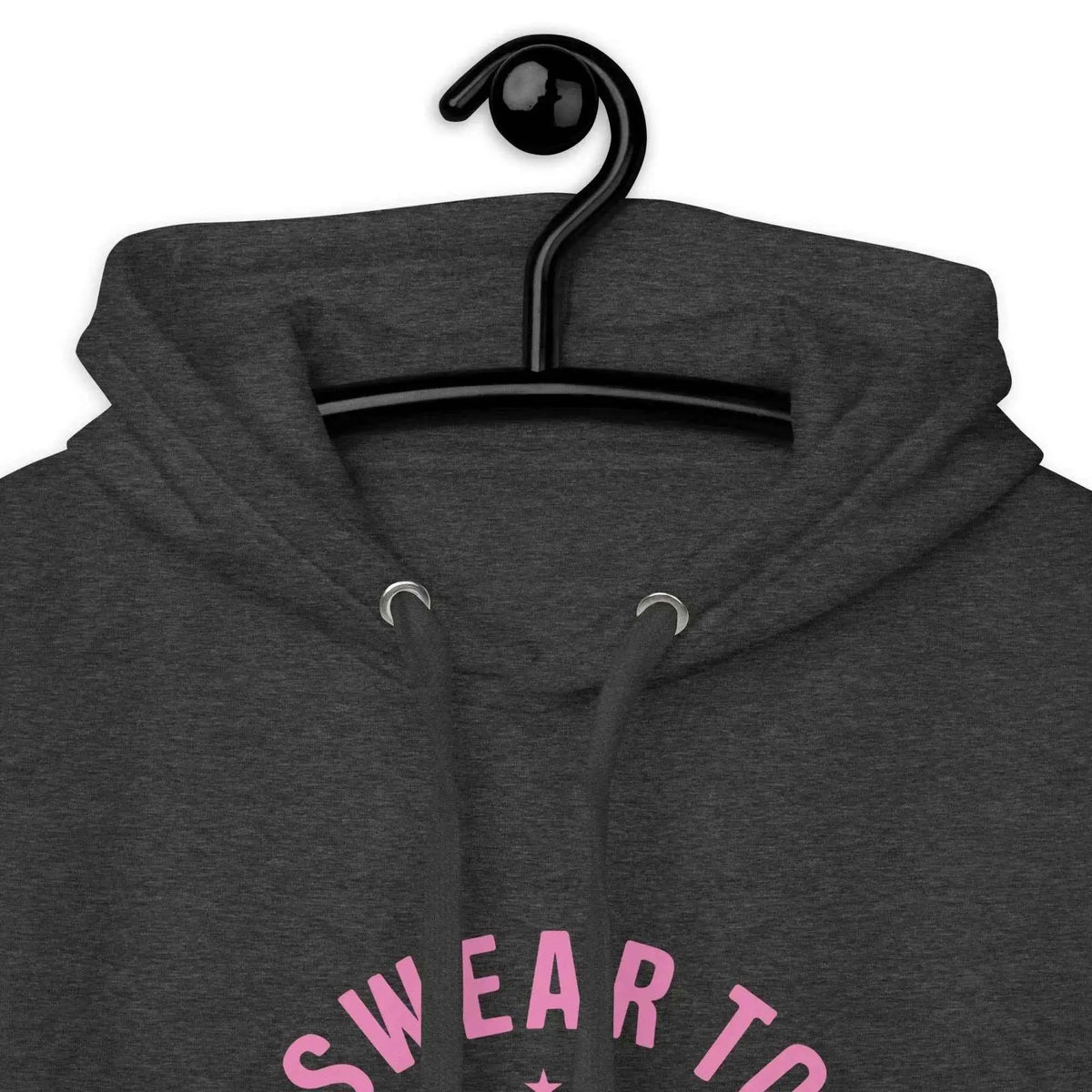 Dark charcoal hoodie close-up with hood drawstrings and pink “Swear to God, I’ll Survive” graphic