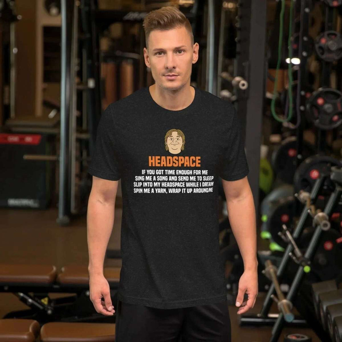 Man wearing black Lewis Capaldi Headspace lyric t-shirt in gym setting with exercise equipment