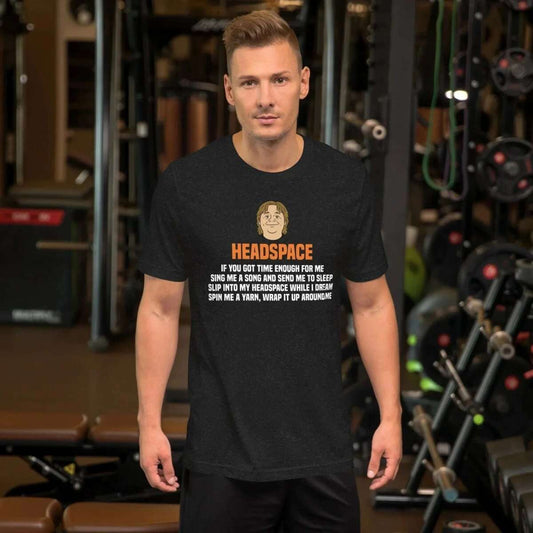 Man wearing black Lewis Capaldi Headspace lyric t-shirt in gym setting with exercise equipment