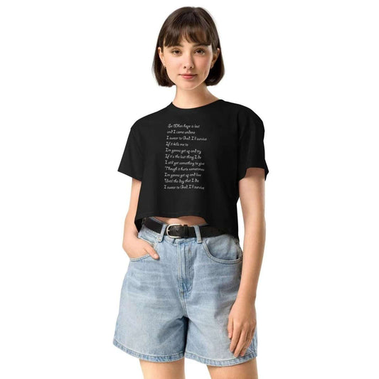 Young woman wearing black crop top with white song lyrics and denim shorts, Lewis Capaldi merchandise