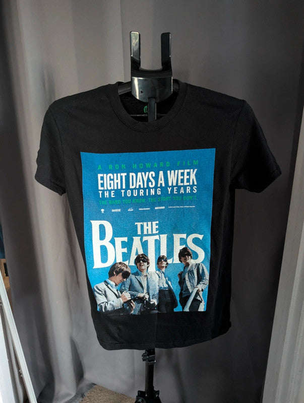 The Beatles black graphic tee featuring vibrant blue and white documentary print.