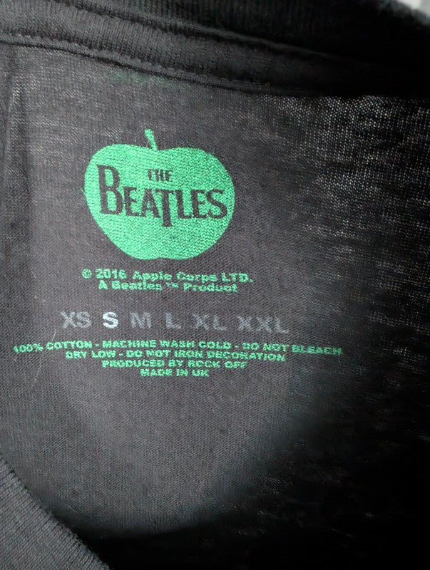 The Beatles black graphic tee featuring vibrant blue and white documentary print.