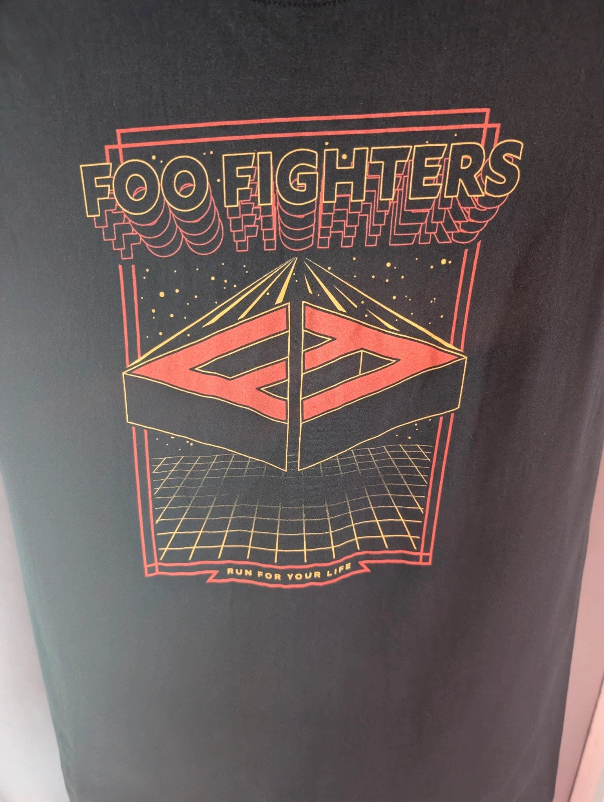 Gildan black pocket t-shirt with Foo Fighters "Run For Your Life" graphic and vibrant colors.