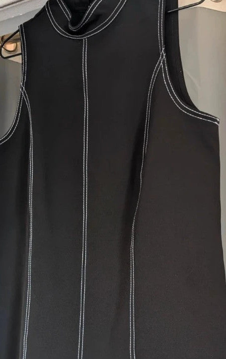 River Island black sleeveless mini dress with white contrast stitching and mock neck collar.