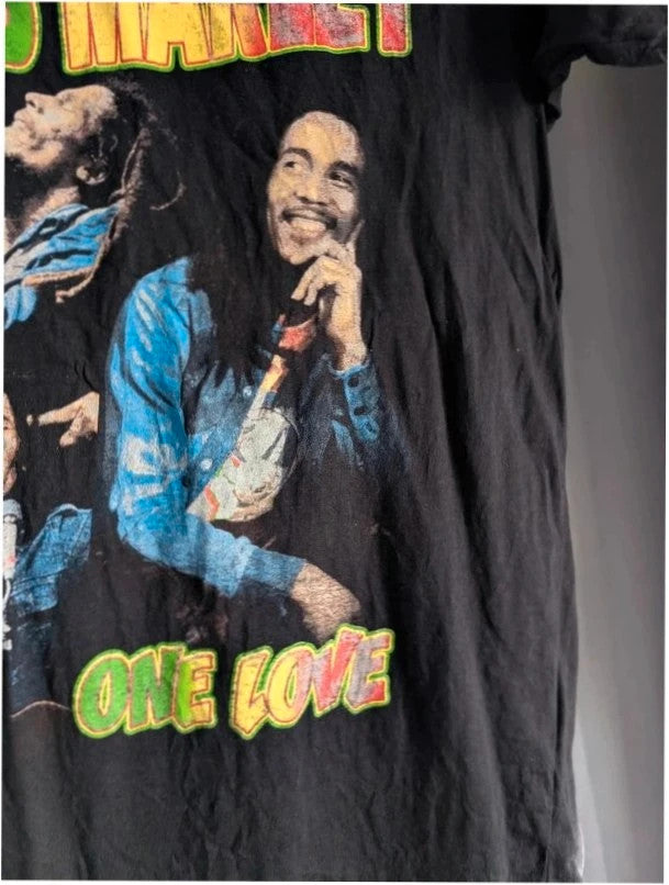 Zion Rootswear black graphic t-shirt featuring Bob Marley portraits and distressed Rasta font.