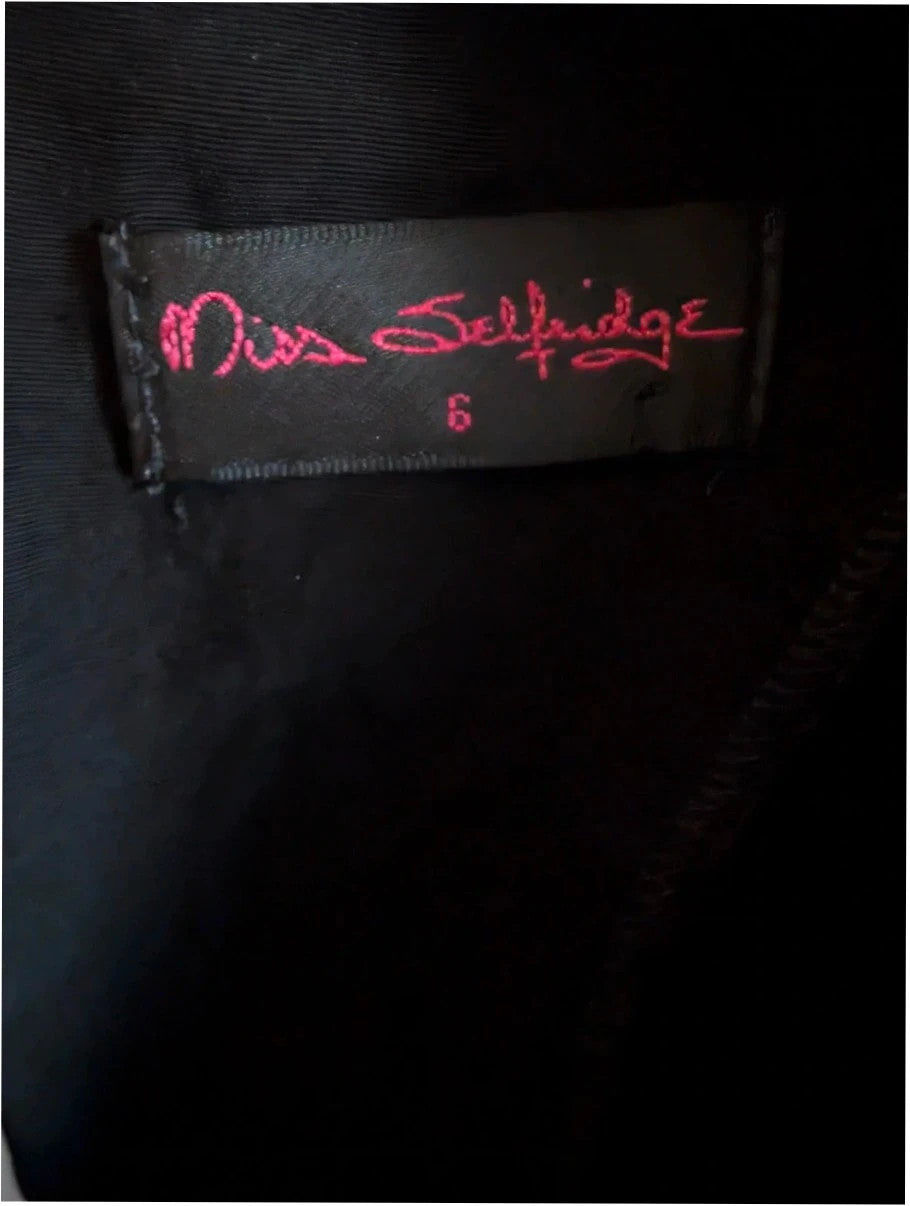 Miss Selfridge black pencil dress with cutout back and button loop fastenings.