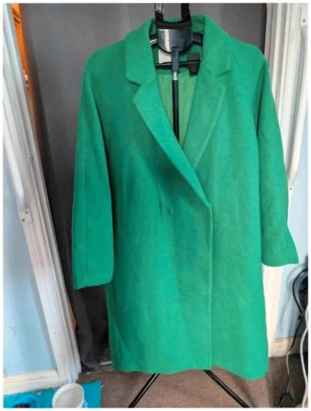 H&M green longline coat with structured shoulders and notch lapel collar.