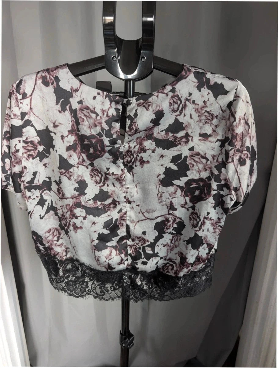 NaaNaa black satin crop top with floral print and eyelash lace trim.