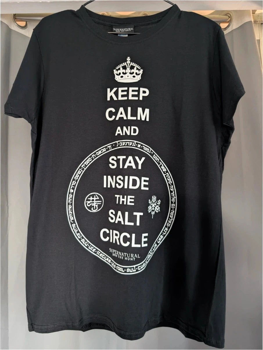 Supernatural black pocket t-shirt with "Stay Inside Salt Circle" graphic and symbols.