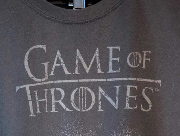 Game of Thrones black graphic tee featuring distressed House Stark direwolf sigil and logo.