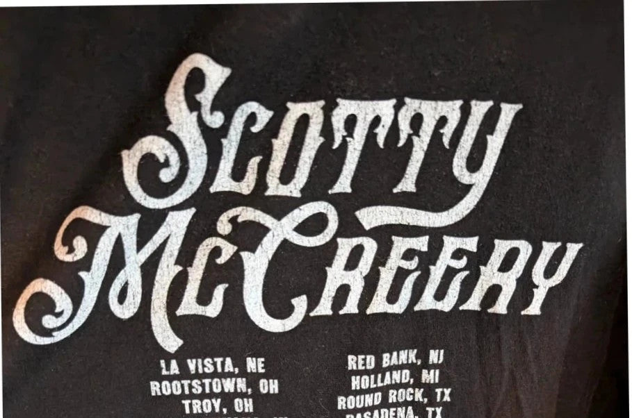 Scotty McCreery black graphic tee featuring retro artwork and US tour dates on back.