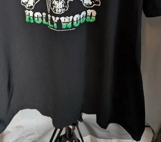 Poison black graphic tee featuring skull and crossbones logo with "Hollywood" print.