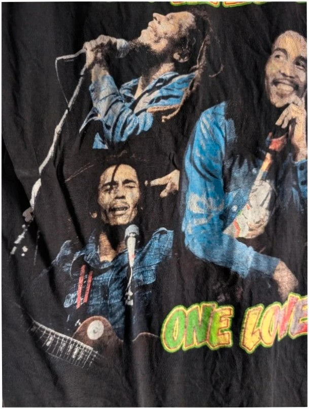Zion Rootswear black graphic t-shirt featuring Bob Marley portraits and distressed Rasta font.
