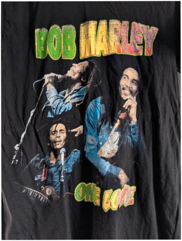 Zion Rootswear black graphic t-shirt featuring Bob Marley portraits and distressed Rasta font.