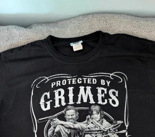 The Walking Dead black graphic tee featuring Rick Grimes and Daryl Dixon print.
