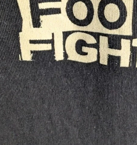 Foo Fighters black graphic tee featuring coiling snake design and blue checkerboard pattern.