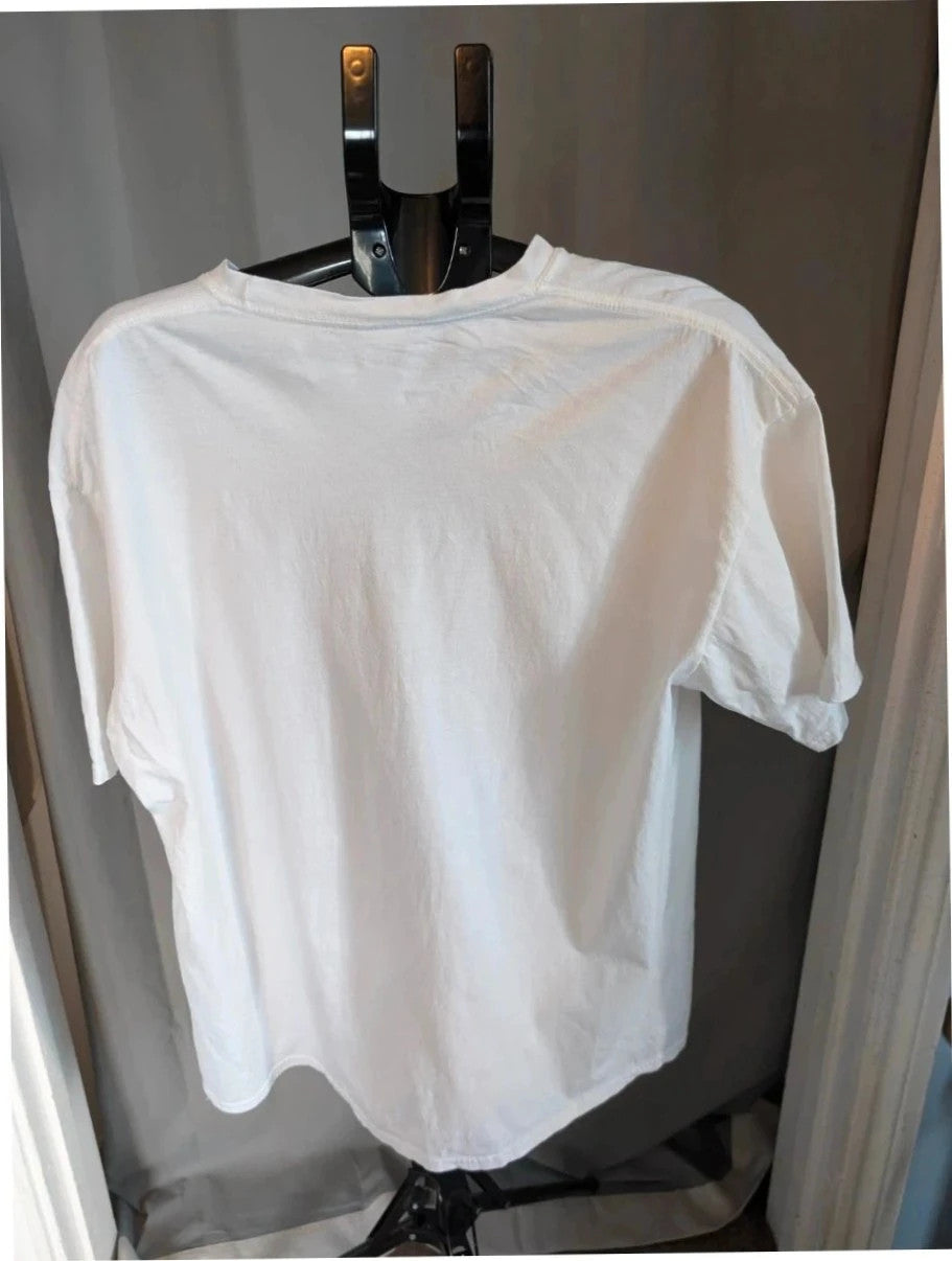 Harry Potter white graphic tee featuring green Slytherin snake crest and medieval armor design.