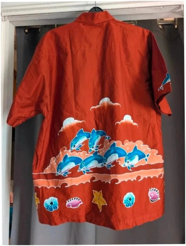 Phuket Batik burgundy graphic tee hand-painted dolphins and embroidered chest pocket detail.