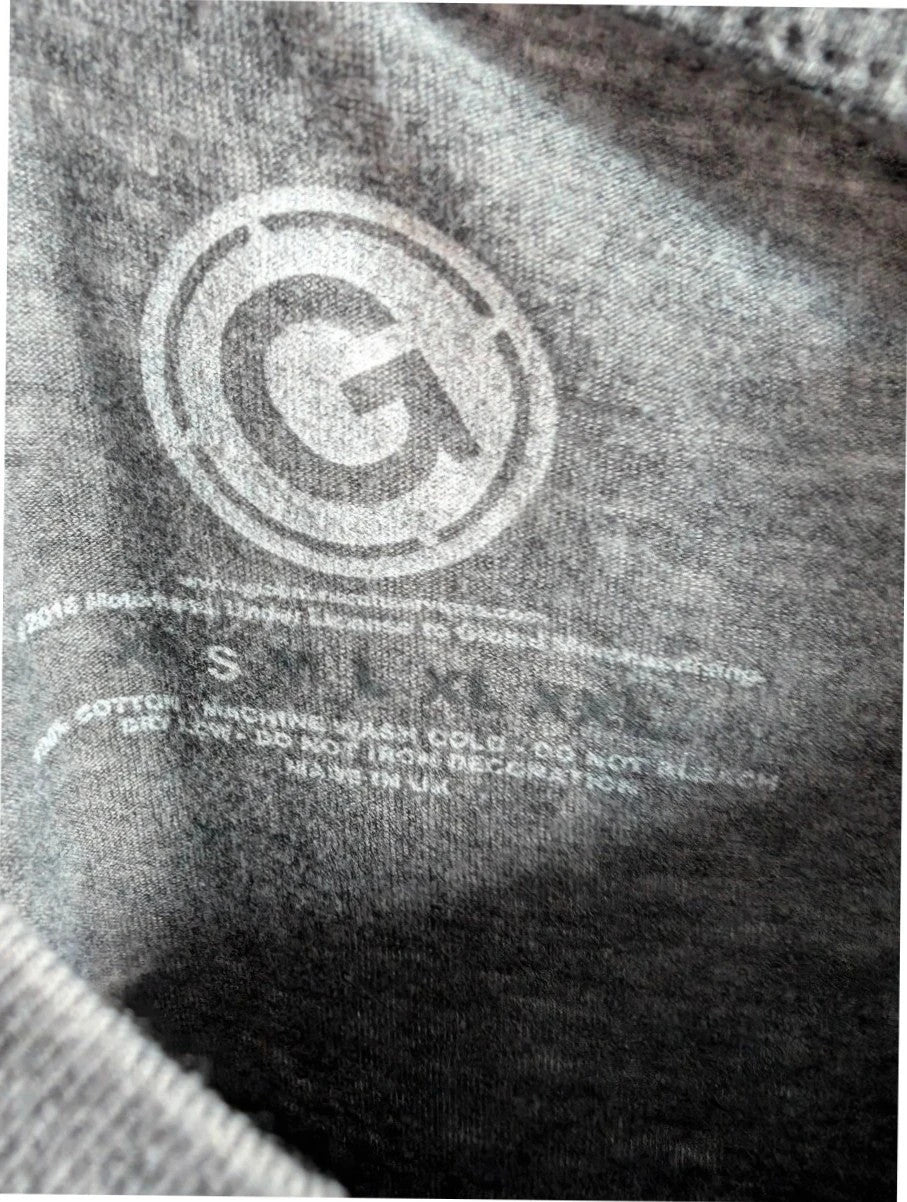 Motörhead grey graphic tee featuring Snaggletooth Warpig emblem and circular print.