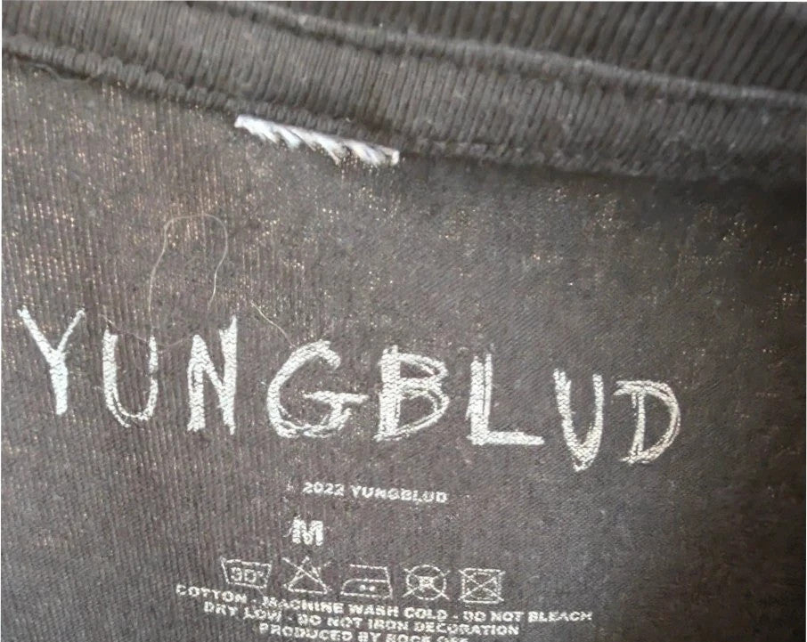 Yungblud black graphic tee with metallic silver portrait and neon pink tour lettering.