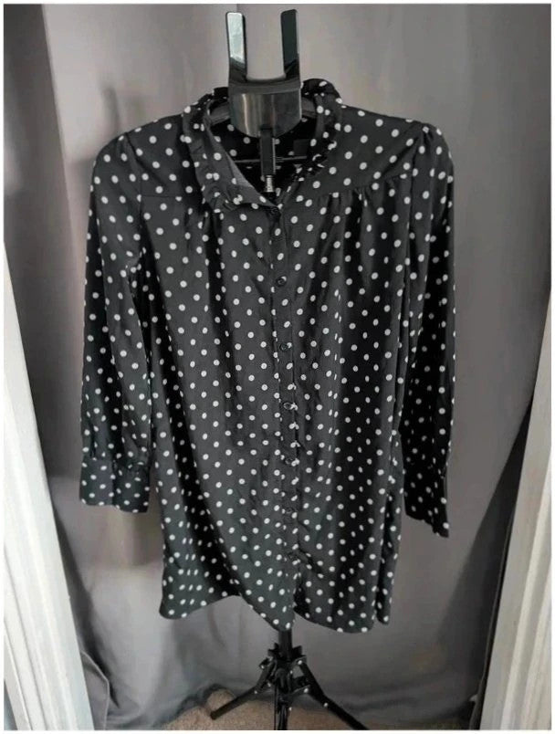 Voyelles black and white polka dot blouse with ruffle collar and button-up front.
