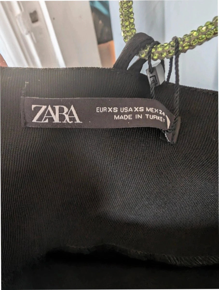 Zara black cowl neck slip dress with lime green rhinestone straps and smooth polyester fabric.