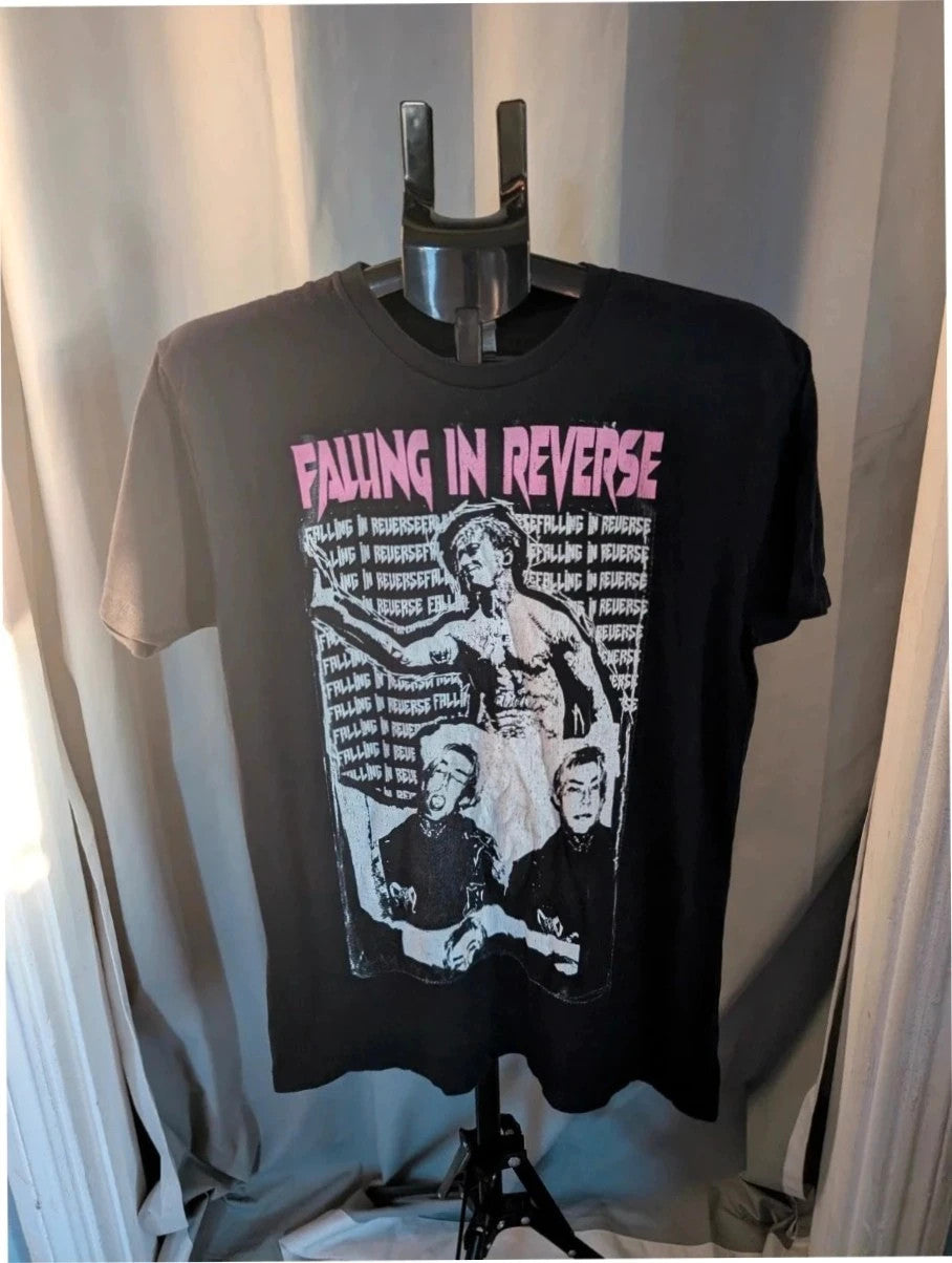 Next Level black graphic tee featuring Falling In Reverse pink logo and band portrait.