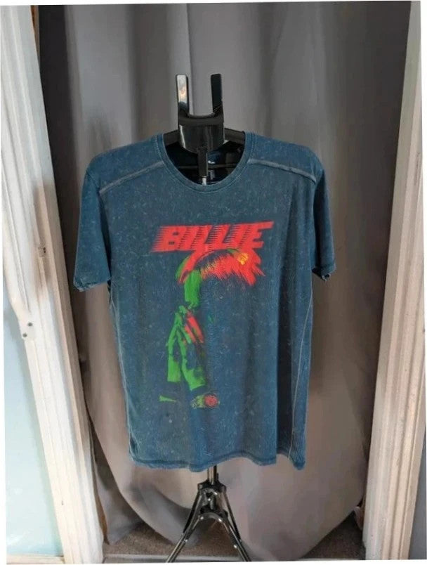 Billie Eilish blue acid wash pocket t-shirt with multicolour graphic and red text.