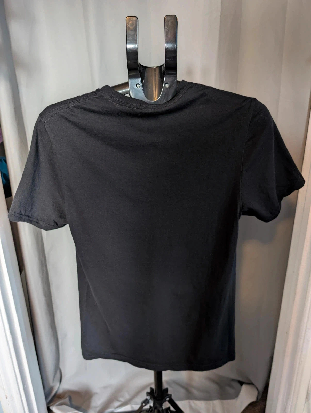 Mötley Crüe black graphic tee featuring retro band collage and red logo lettering.