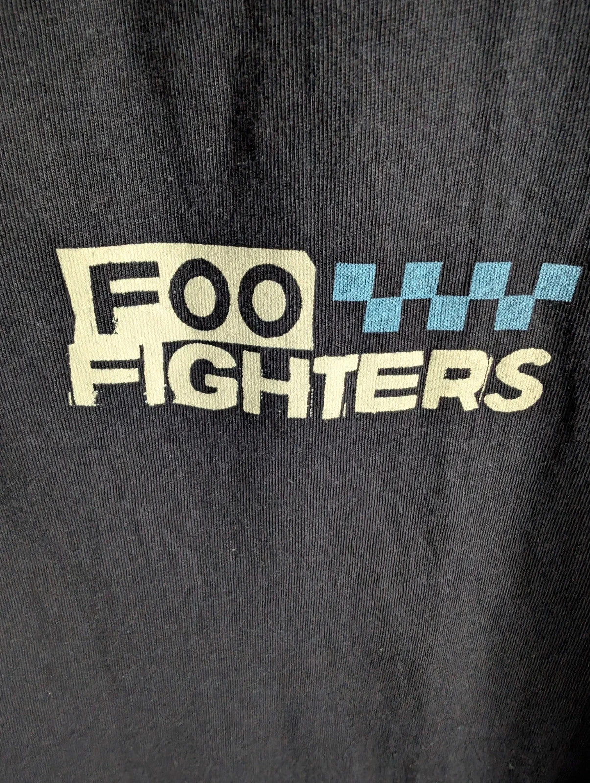 Foo Fighters black graphic tee with coiling snake and checkerboard pattern, soft cotton.