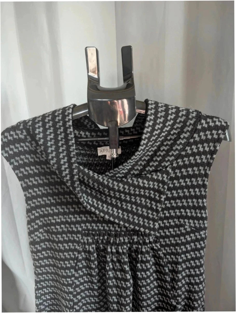 Apricot black and grey knit tunic dress with cowl neck and geometric pattern.