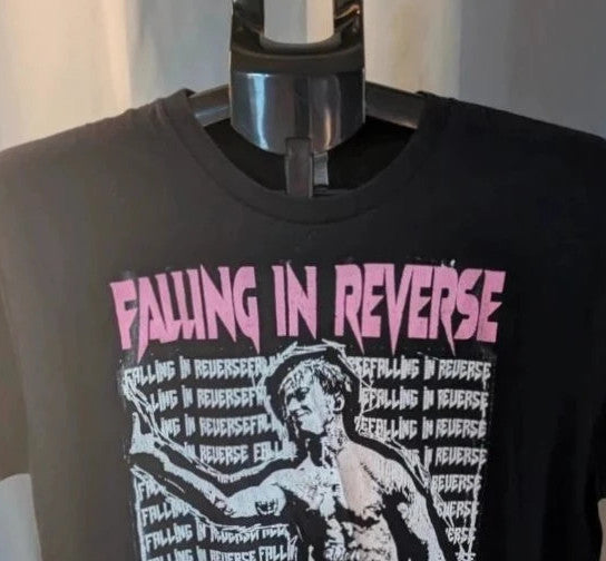 Next Level black graphic tee featuring Falling In Reverse pink logo and band portrait.