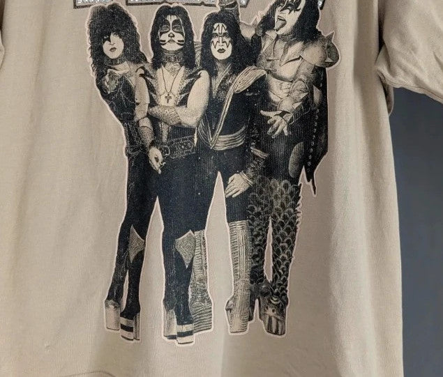 Kiss beige pocket t-shirt with rhinestone logo and band photo graphic.