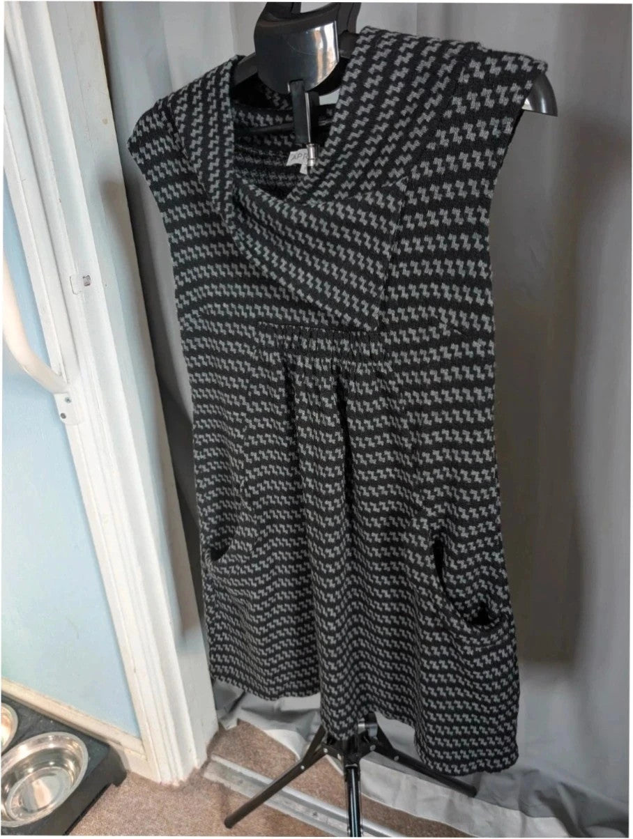 Apricot black and grey knit tunic dress with cowl neck and geometric pattern.