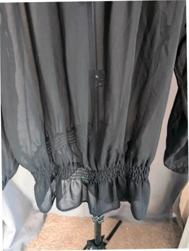 Next black sheer long sleeve blouse with tie neck and ruffle hem detail.