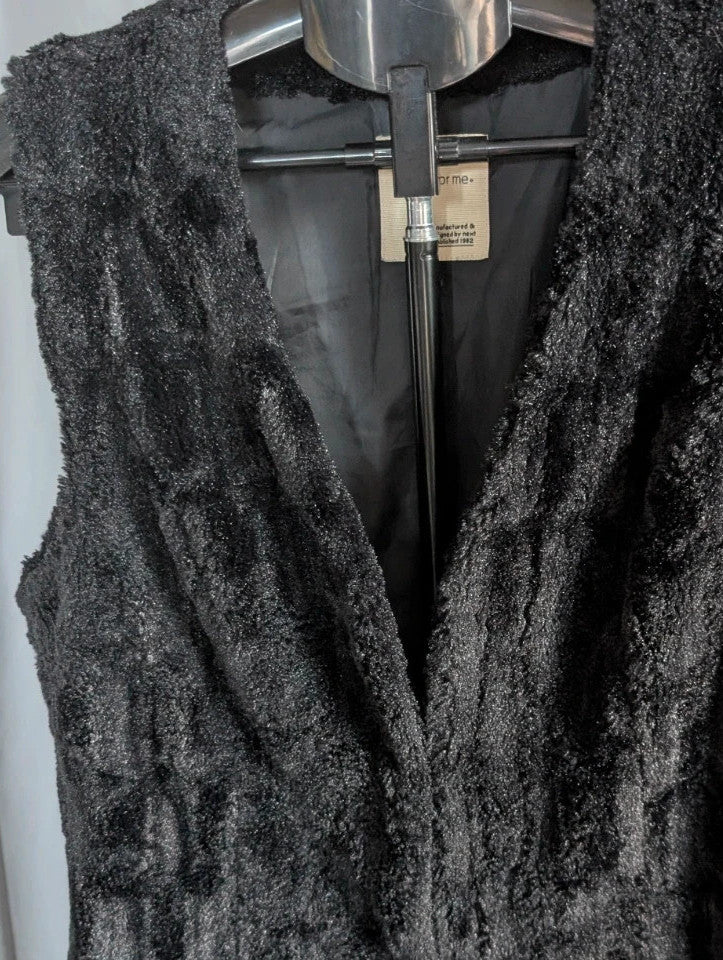 Next black textured faux fur gilet waistcoat with plush waffle pattern and deep V-neckline.