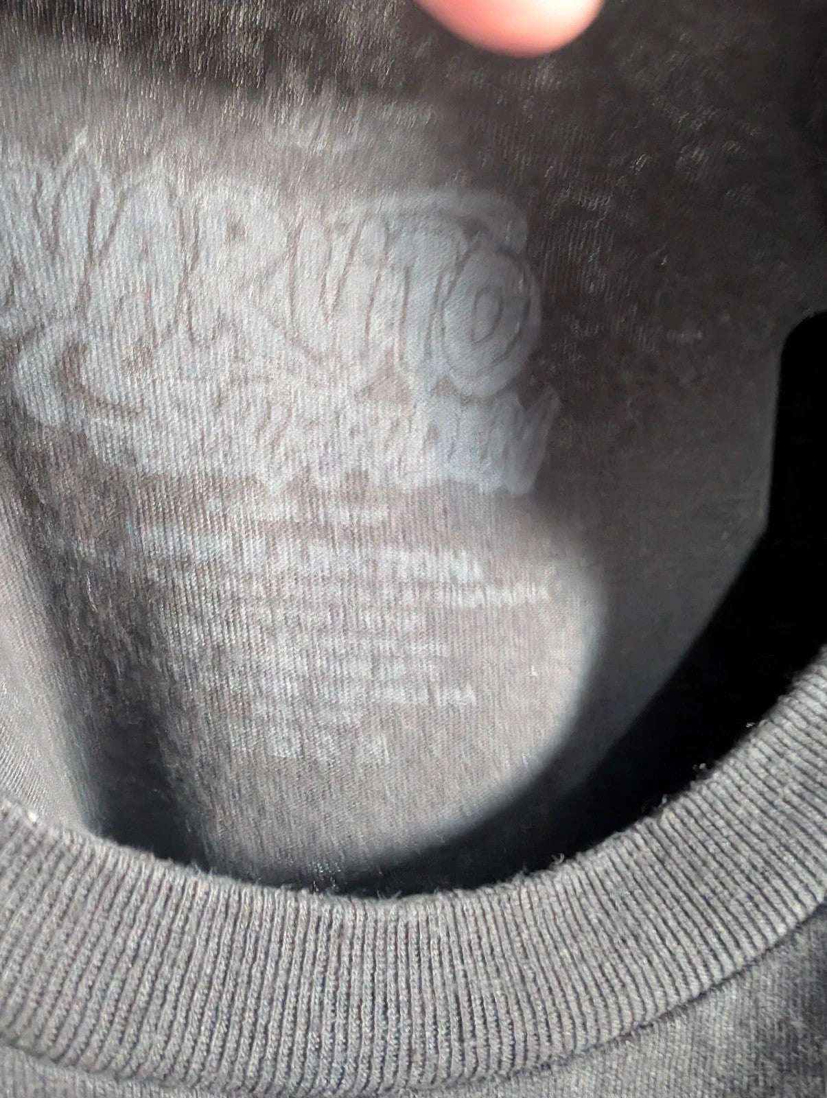 Naruto black graphic t-shirt featuring Kakashi Hatake, bubble typography, and Sharingan eye design.