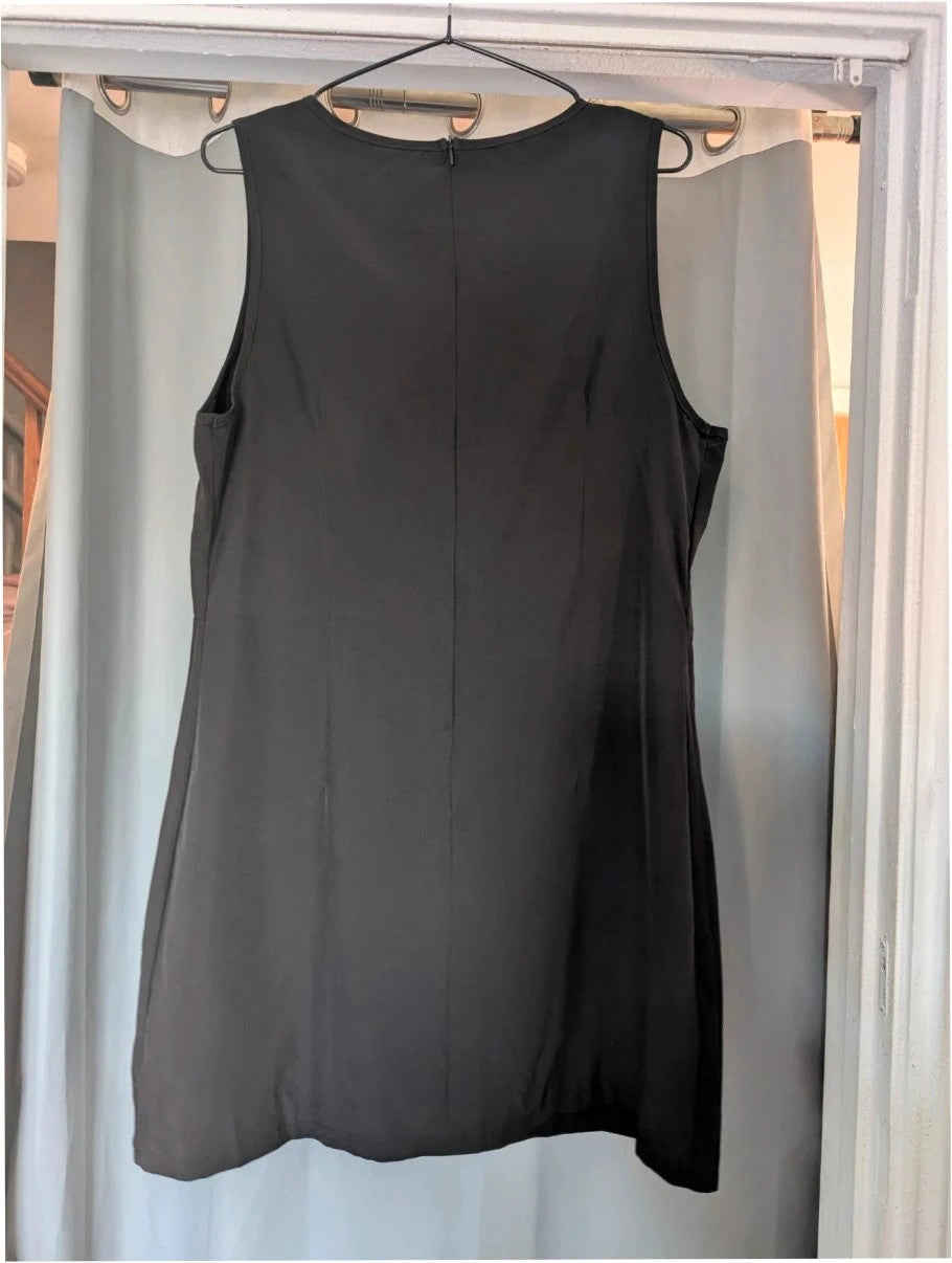 SHEIN black sleeveless mini dress with front flap pockets and back zip fastening.