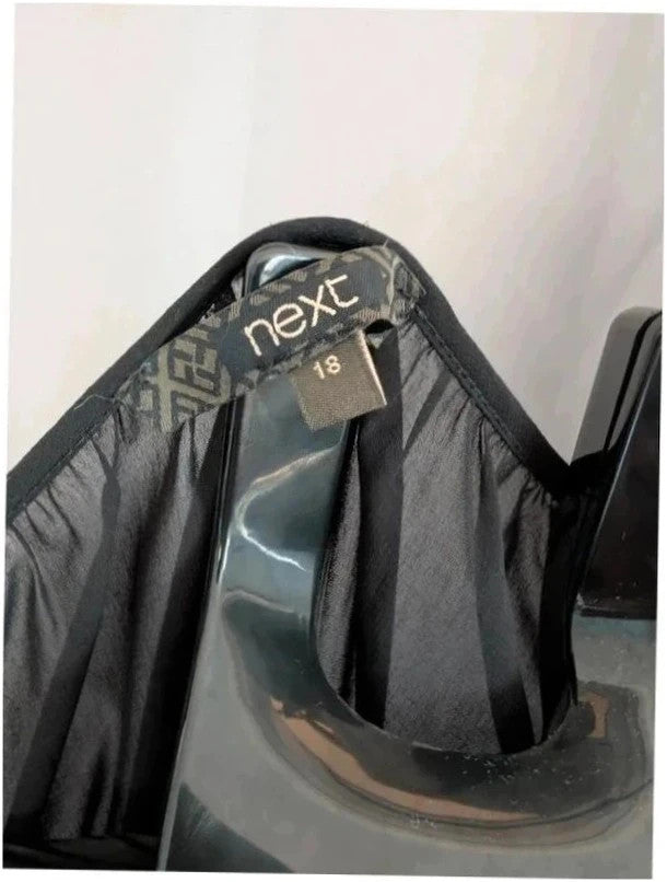 Next black sheer long sleeve blouse with tie neck and ruffle hem detail.
