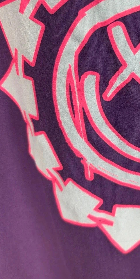Blink-182 purple graphic tee featuring smiley face logo with neon pink outlining and drip detailing.