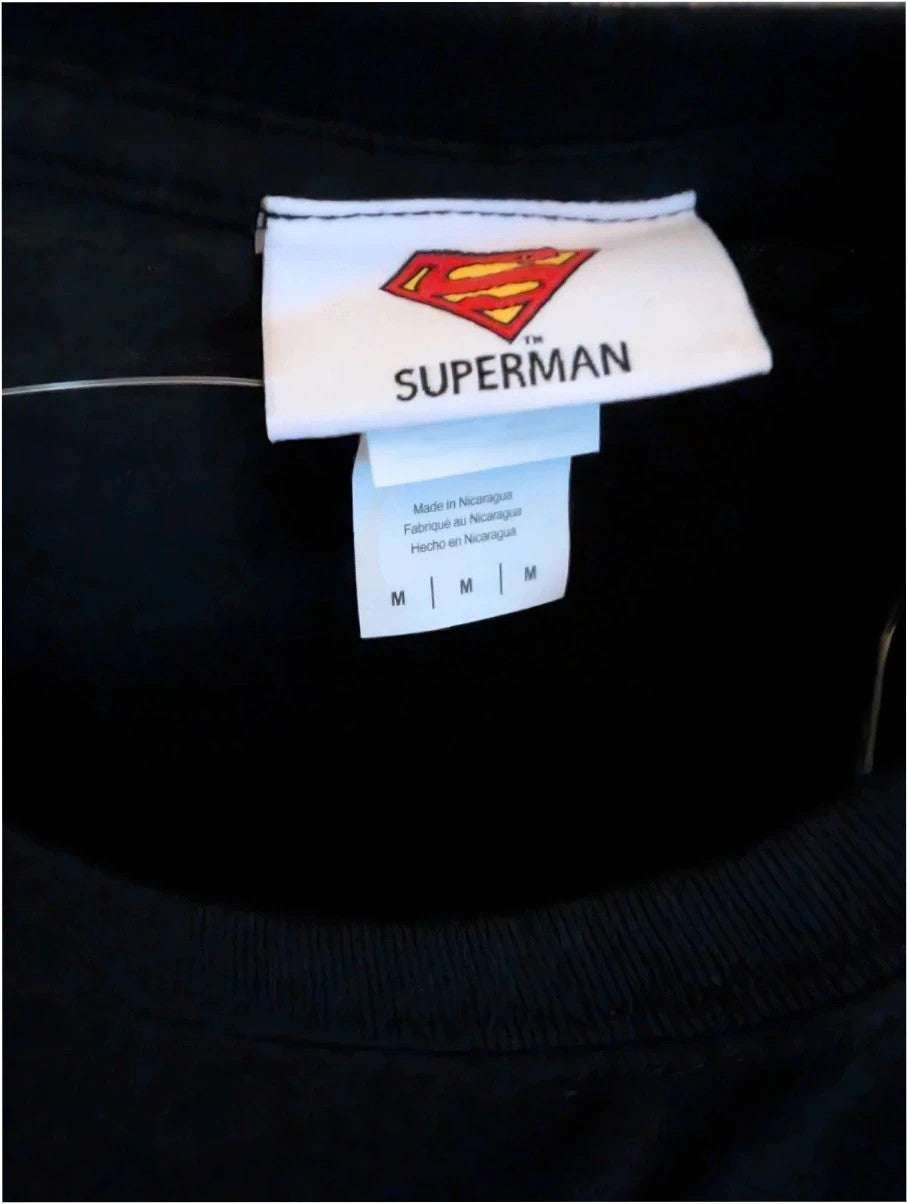 Superman black graphic tee with distressed metallic orange shield logo on soft cotton.