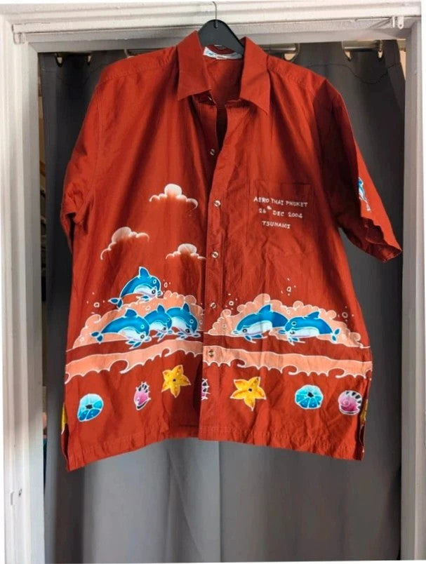 Phuket Batik burgundy graphic tee with hand-painted dolphins and commemorative embroidered pocket.