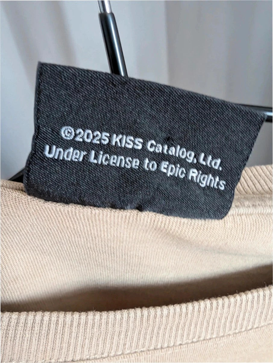 Kiss beige pocket t-shirt with rhinestone logo and band photo graphic.