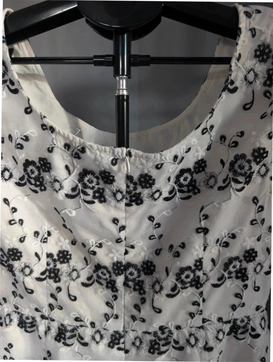 Yumi black and white floral embroidered mesh overlay dress with fitted waist and flared skirt.