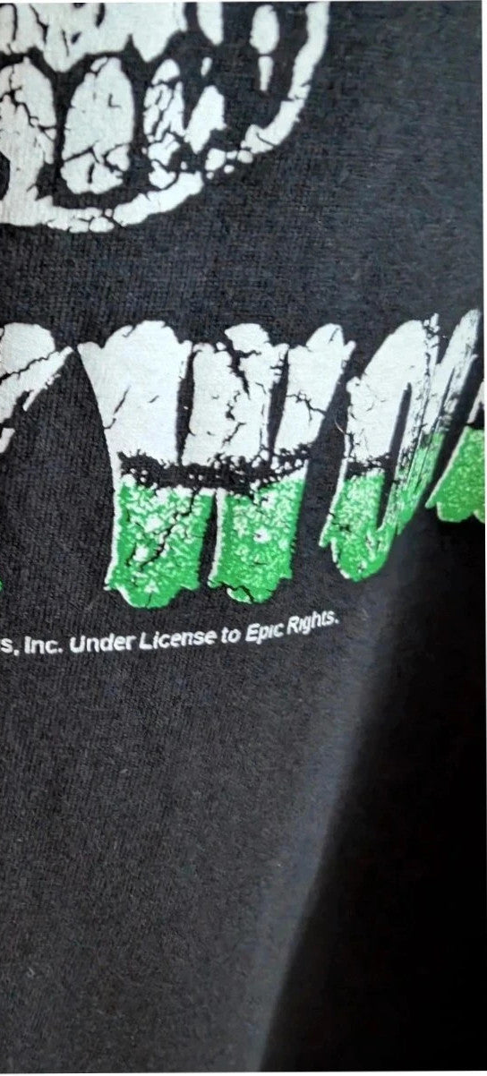 Poison black graphic tee featuring iconic skull and crossbones logo with green and white print.